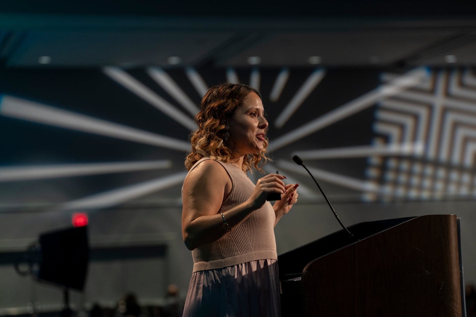 Keynote speaker at a conference podium